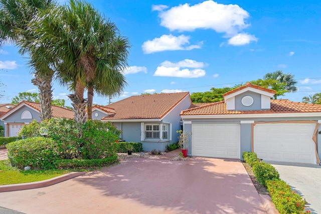 9904 Summerbrook Ter Unit C, Boynton Beach, FL 33437 - mediterranean / spanish-style home with stucco siding, concrete driveway, and a tiled roof