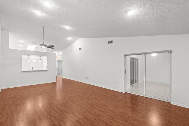 9904 Summerbrook Ter Unit C, Boynton Beach, FL 33437 - unfurnished living room featuring lofted ceiling, ceiling fan, wood finished floors, a textured ceiling, and baseboards