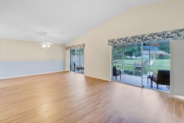 empty room featuring ceiling fan, light hardwood / wood-style flooring, and vaulted ceiling