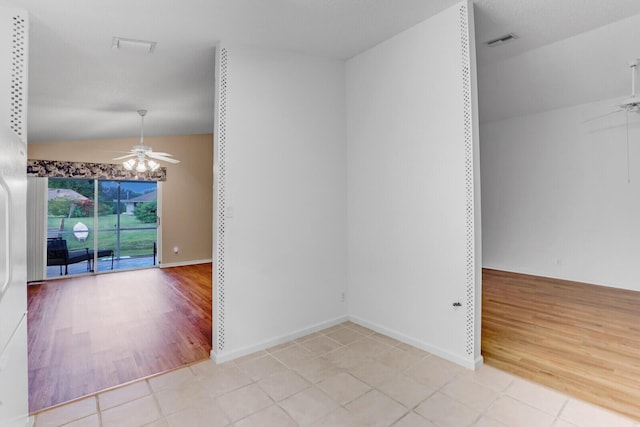 tiled spare room with ceiling fan and lofted ceiling