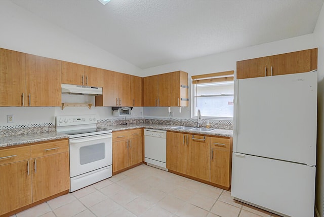 kitchen featuring white appliances, lofted ceiling, and sink