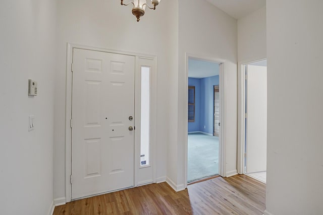 entryway with a chandelier and light hardwood / wood-style flooring