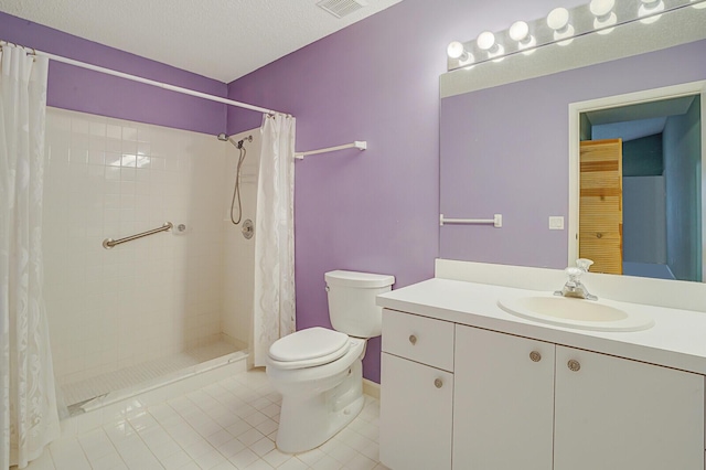 bathroom with a textured ceiling, vanity, toilet, and walk in shower