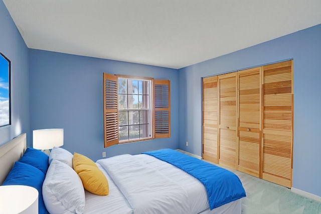 bedroom with light carpet and a closet