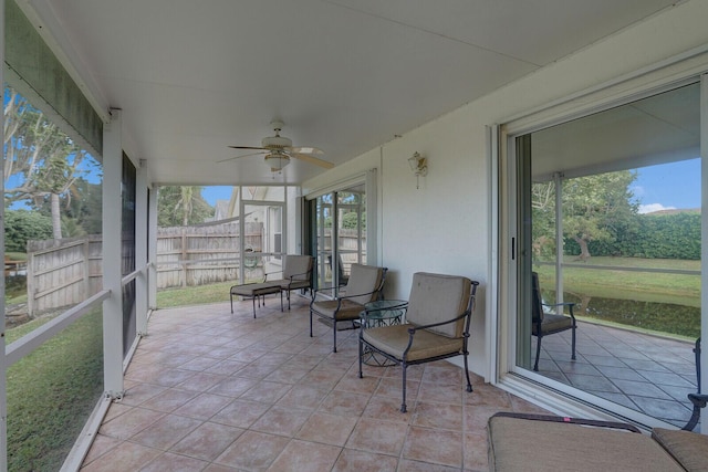 sunroom / solarium featuring ceiling fan