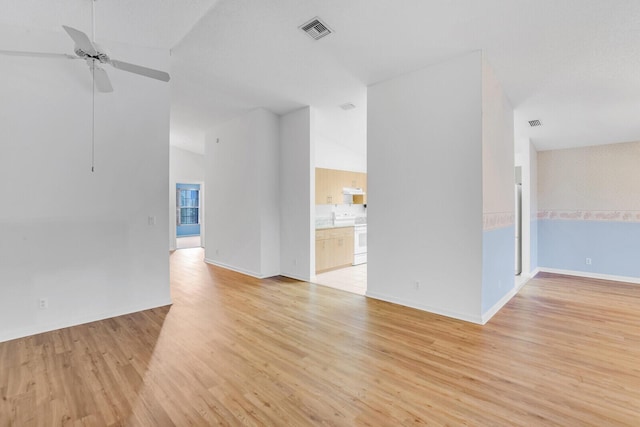 unfurnished room with ceiling fan, light wood-type flooring, and vaulted ceiling