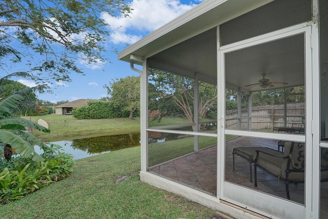 exterior space with a water view, ceiling fan, and a sunroom