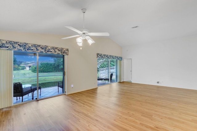 empty room with ceiling fan, light hardwood / wood-style floors, and lofted ceiling