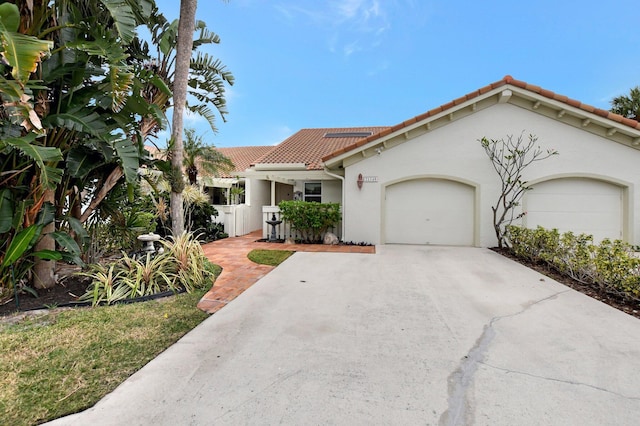 mediterranean / spanish home with a garage