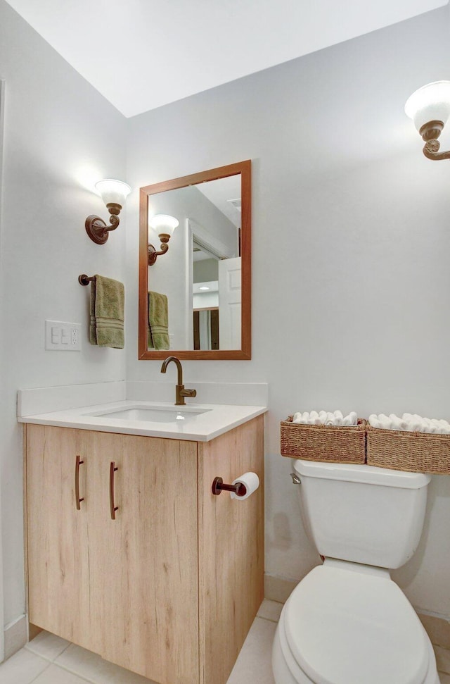 bathroom with tile patterned flooring, vanity, and toilet