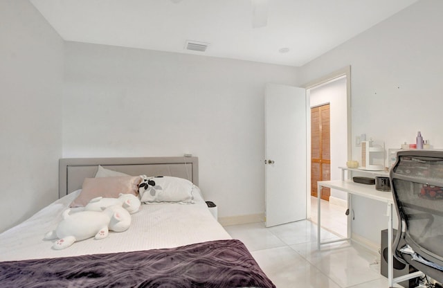 bedroom featuring a closet and light tile patterned floors