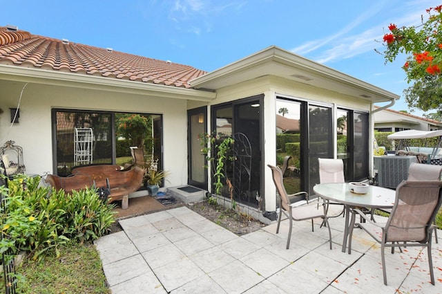 view of patio featuring a sunroom