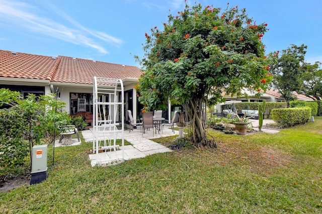 back of property featuring a yard and a patio