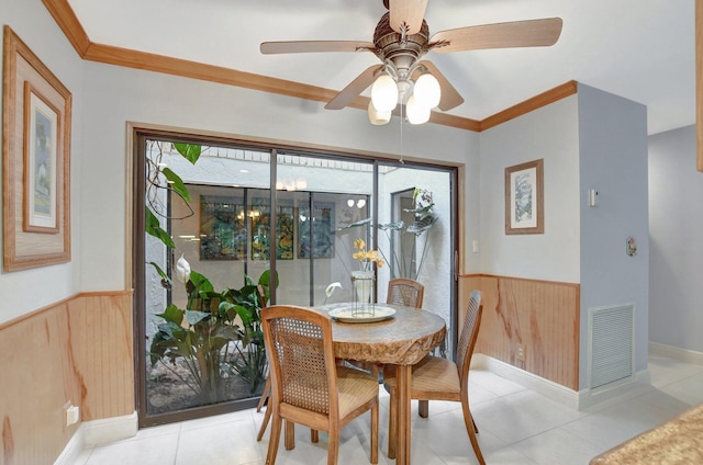 dining area featuring ceiling fan, ornamental molding, and light tile patterned floors