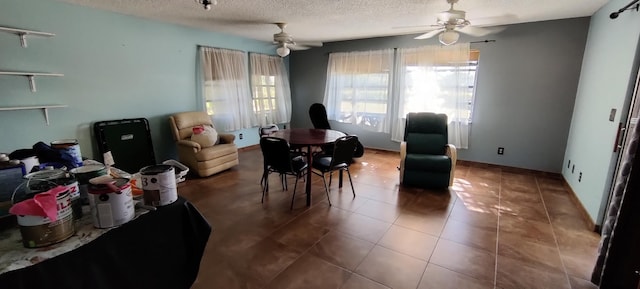 dining room with tile patterned floors, ceiling fan, and a textured ceiling