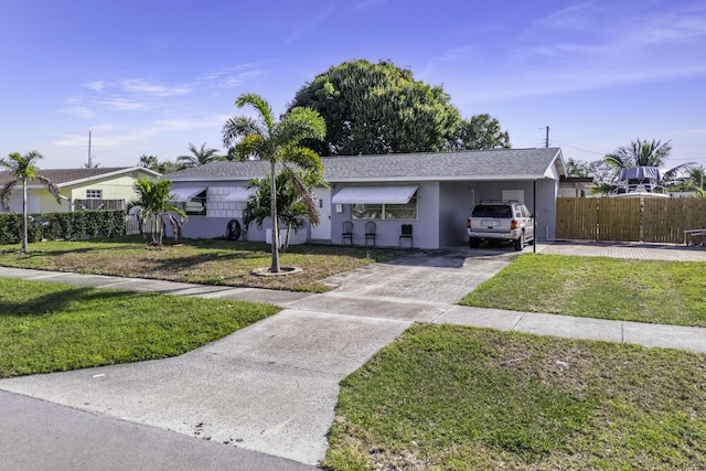 ranch-style home with a carport and a front yard