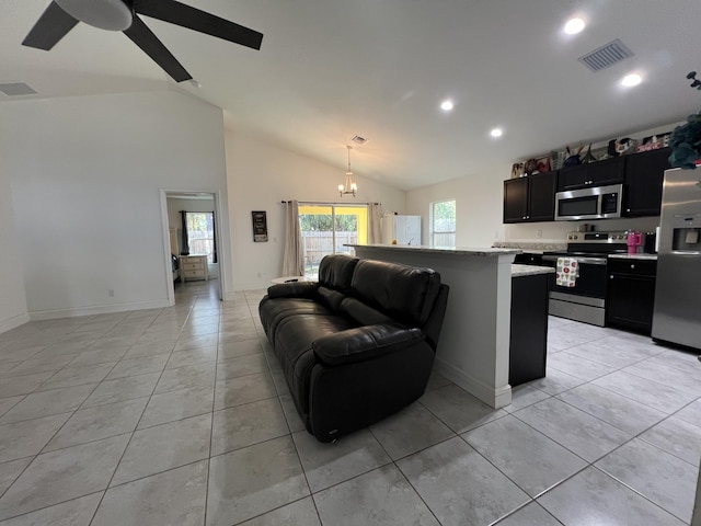 living room featuring vaulted ceiling, ceiling fan with notable chandelier, and light tile patterned floors