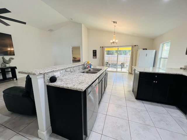 kitchen featuring vaulted ceiling, sink, stainless steel dishwasher, and an island with sink