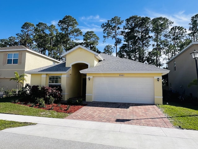 view of front of home with a garage and a front yard