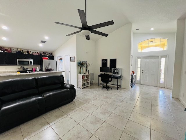 tiled living room with high vaulted ceiling and ceiling fan