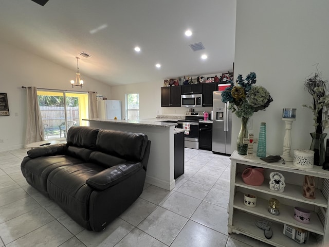 tiled living room featuring lofted ceiling and an inviting chandelier