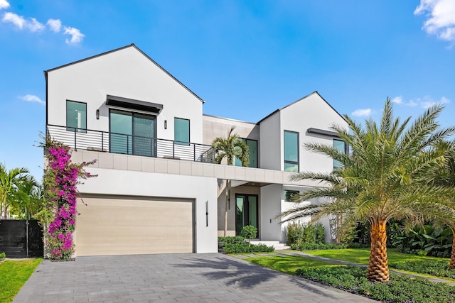 contemporary home with a garage and a balcony