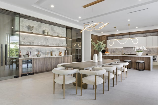 dining room with a tray ceiling and an inviting chandelier