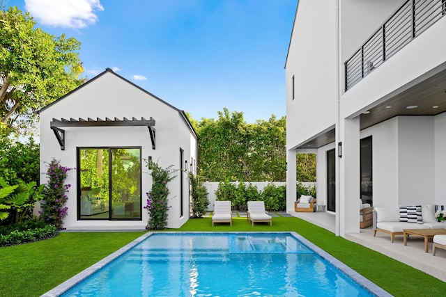 view of swimming pool featuring a lawn and a patio area