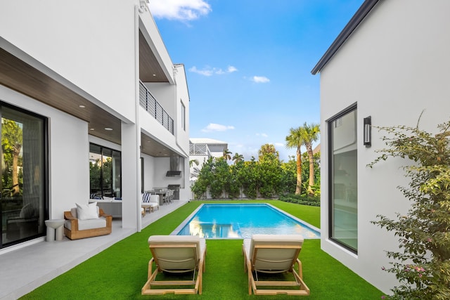 view of pool featuring a patio area and a yard