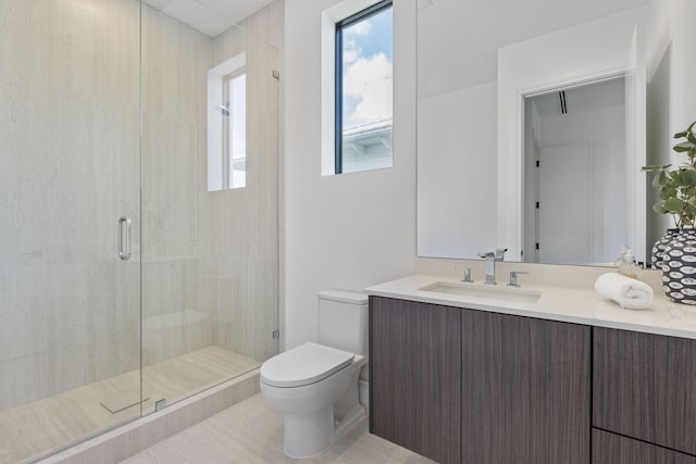 bathroom featuring vanity, toilet, and a shower with door