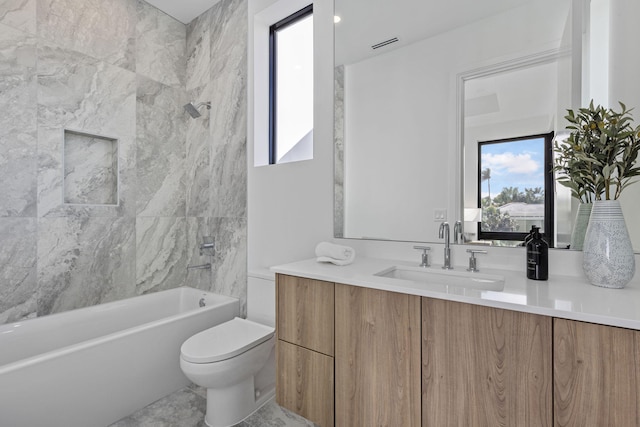 full bathroom with tiled shower / bath, vanity, a healthy amount of sunlight, and toilet