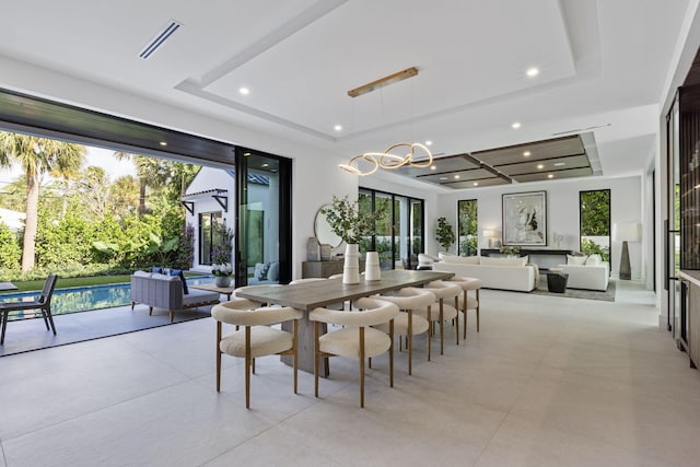 dining room with a raised ceiling and an inviting chandelier