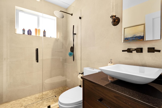 bathroom with a shower with door, sink, decorative backsplash, toilet, and tile walls