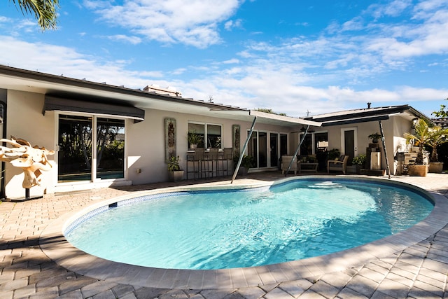 view of swimming pool featuring a patio