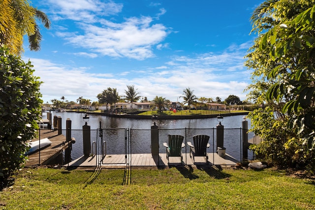 dock area featuring a water view and a yard