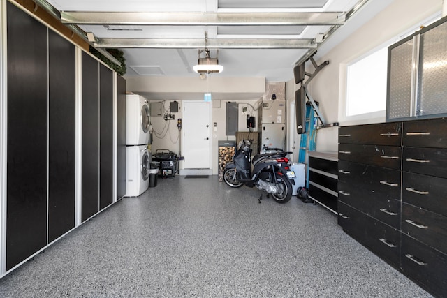 garage featuring stacked washer / drying machine, electric panel, white refrigerator, and a garage door opener