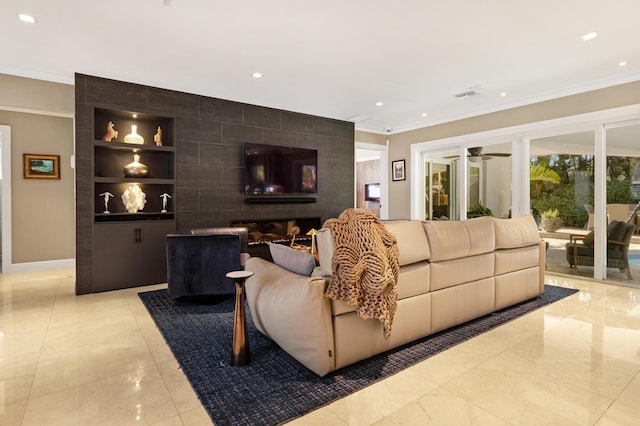 living room with built in shelves and ceiling fan