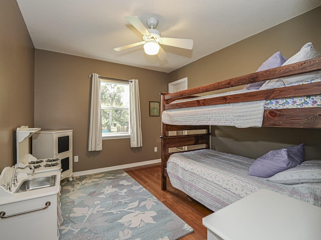 bedroom featuring ceiling fan and dark hardwood / wood-style flooring