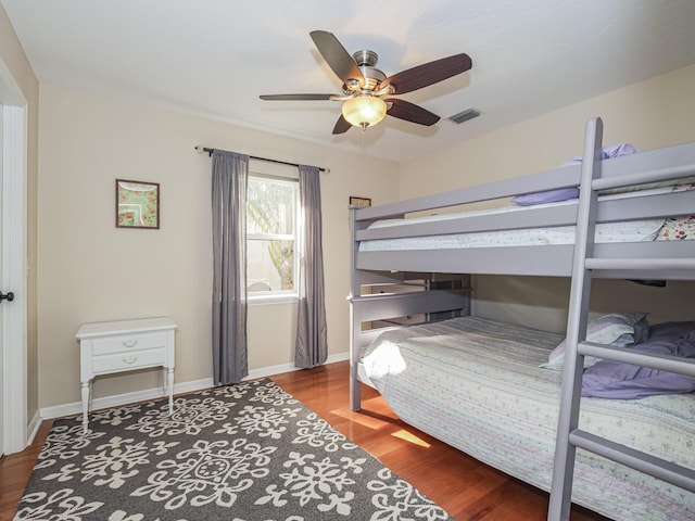 bedroom with ceiling fan and hardwood / wood-style floors