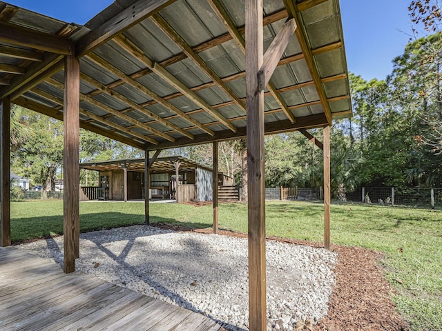 wooden deck with an outbuilding and a lawn