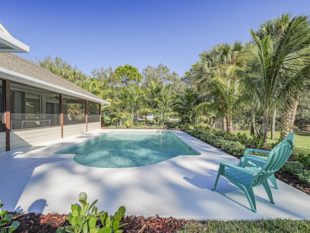 view of swimming pool with a sunroom