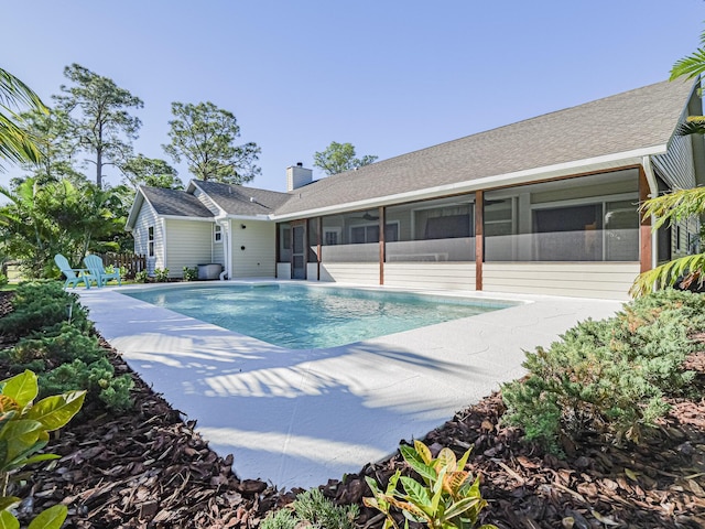 view of pool featuring a sunroom