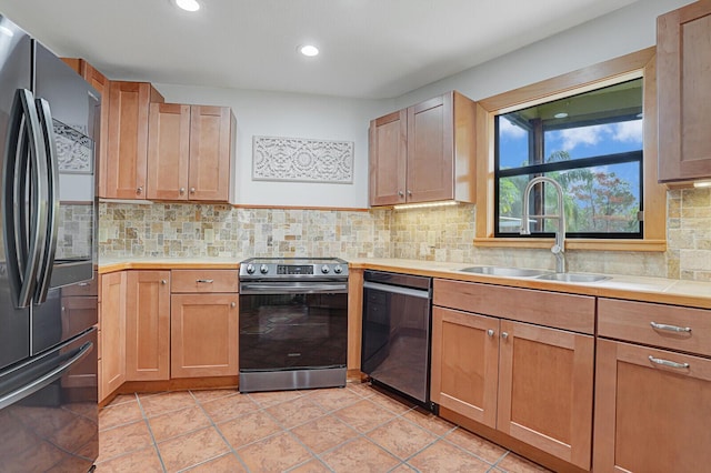 kitchen featuring backsplash, electric stove, sink, black dishwasher, and fridge