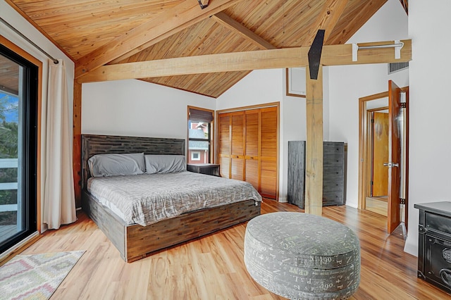 bedroom featuring lofted ceiling with beams, light hardwood / wood-style flooring, a closet, and wood ceiling