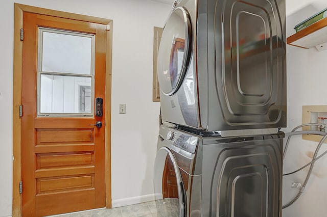 washroom featuring stacked washer / drying machine