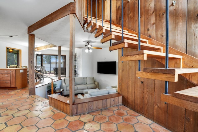 stairs featuring tile patterned floors and ceiling fan