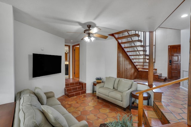 living room featuring light tile patterned floors and ceiling fan