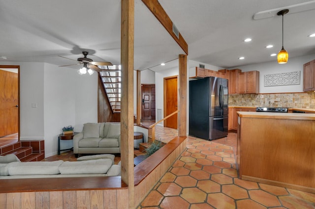 kitchen with stainless steel refrigerator, ceiling fan, tasteful backsplash, decorative light fixtures, and light tile patterned flooring