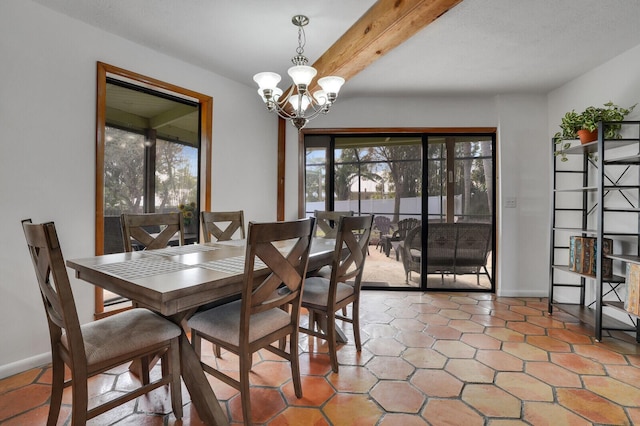 dining space with beamed ceiling and a chandelier