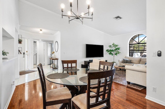 dining area featuring a chandelier, hardwood / wood-style floors, and ornamental molding